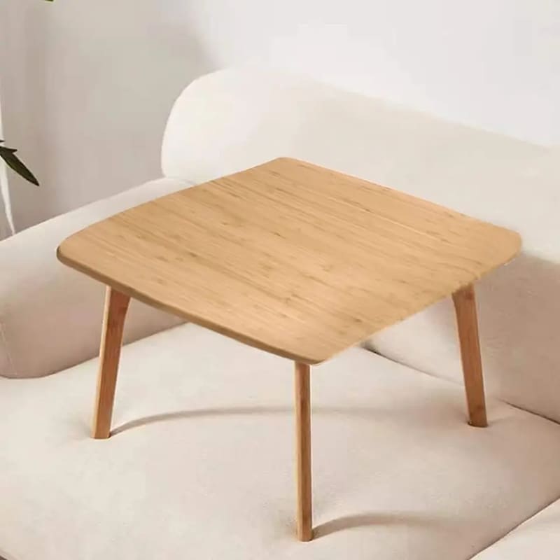 Een low theetafel ligt op de vloer van een vierkante tatami -tafel bamboe meubels